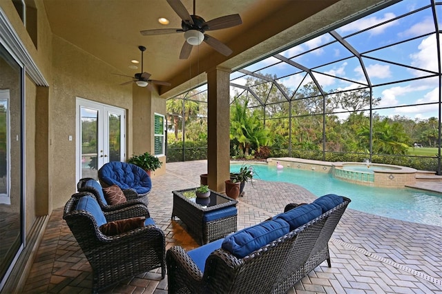 view of patio / terrace featuring glass enclosure, a ceiling fan, an outdoor living space, a pool with connected hot tub, and french doors