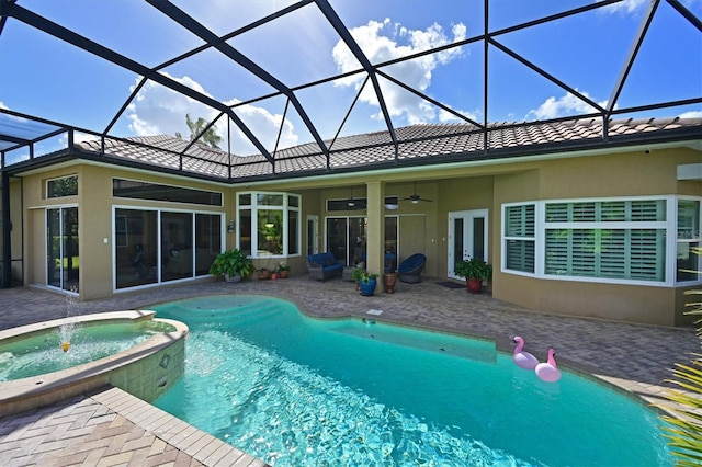 10209 Discovery Ter, Bradenton, FL 34212 - back of house with a patio area, stucco siding, ceiling fan, a pool with connected hot tub, and a tiled roof