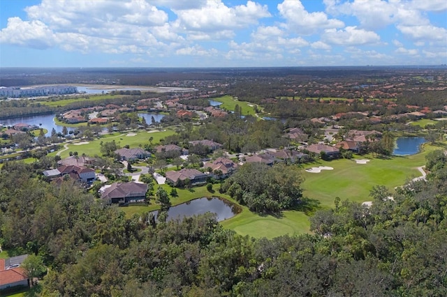 aerial view with golf course view, a water view, and a residential view