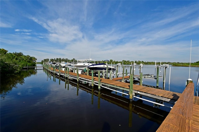 dock area featuring boat lift and a water view