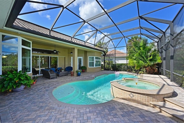 view of pool with a pool with connected hot tub, ceiling fan, glass enclosure, an outdoor hangout area, and a patio