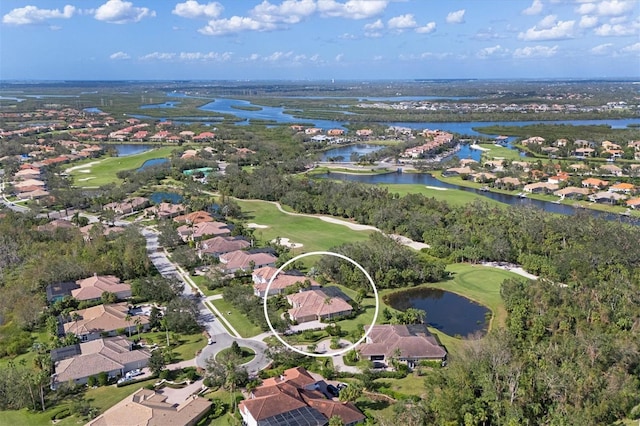 aerial view with a residential view, a water view, and golf course view