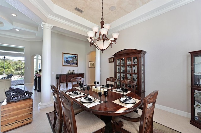 dining area featuring a chandelier, decorative columns, light tile patterned floors, arched walkways, and a raised ceiling