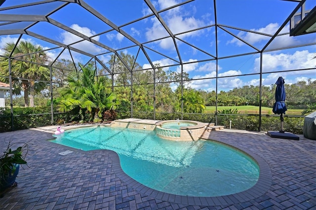 view of pool featuring a patio area, a lanai, and a pool with connected hot tub