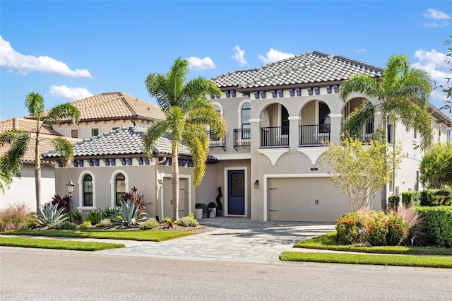 mediterranean / spanish-style house featuring a balcony and a garage