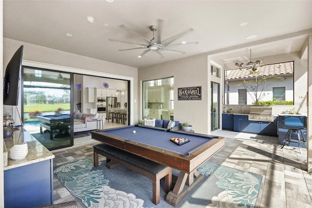 game room featuring ceiling fan with notable chandelier and pool table