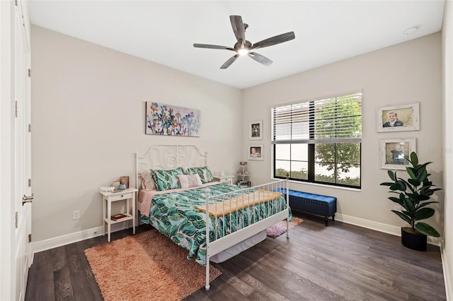 bedroom with ceiling fan and dark hardwood / wood-style flooring