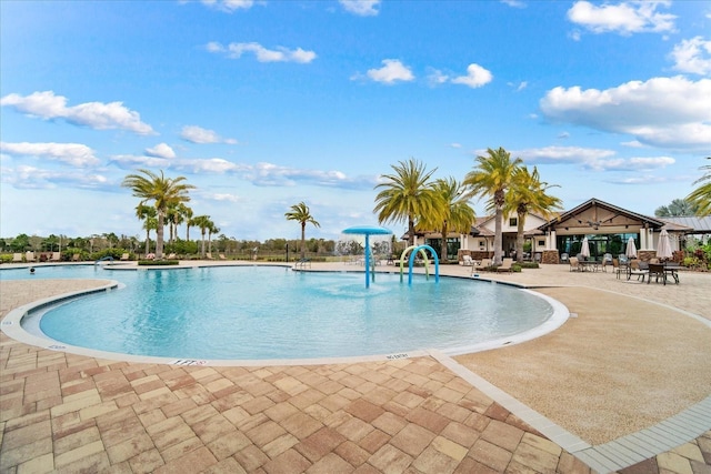 view of swimming pool featuring pool water feature and a patio area