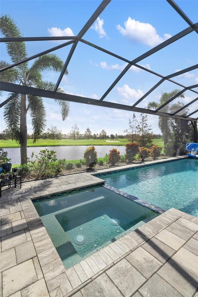 view of pool with an in ground hot tub, a patio, a water view, and glass enclosure