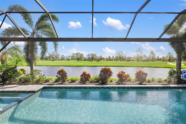 view of swimming pool featuring glass enclosure and a water view