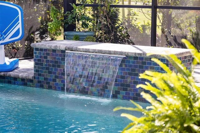 view of swimming pool featuring pool water feature