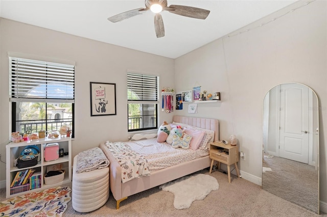 bedroom with carpet, ceiling fan, and multiple windows