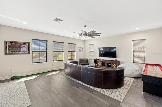 living room featuring ceiling fan and hardwood / wood-style flooring