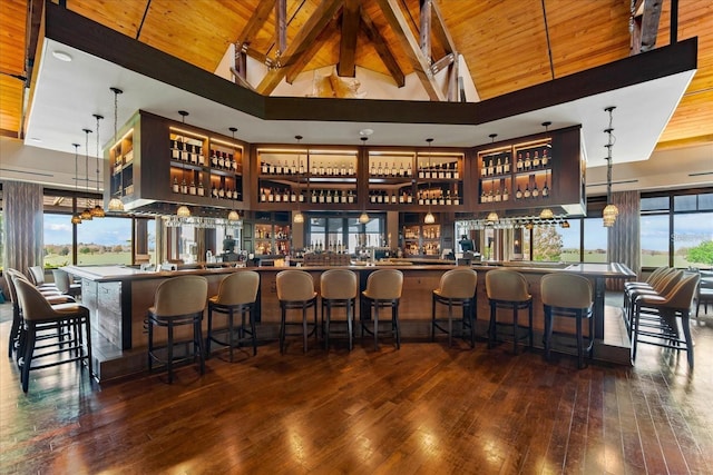 bar featuring beam ceiling, dark hardwood / wood-style flooring, wooden ceiling, and high vaulted ceiling