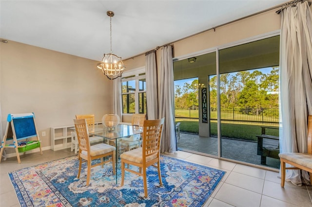 dining area with light tile patterned floors and a chandelier