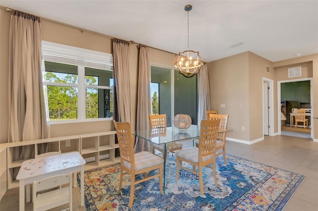 dining space with tile patterned floors and a notable chandelier