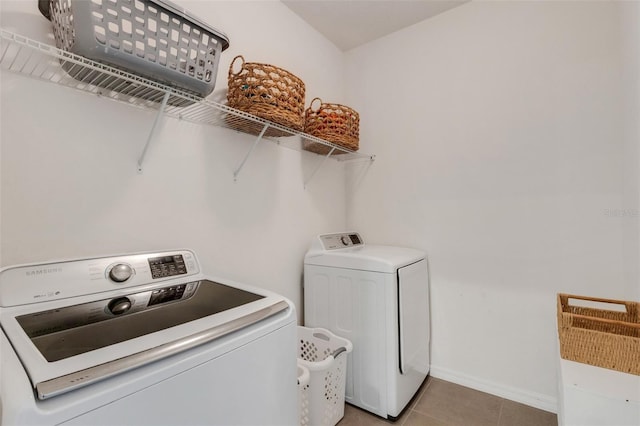 washroom with tile patterned flooring and washing machine and dryer