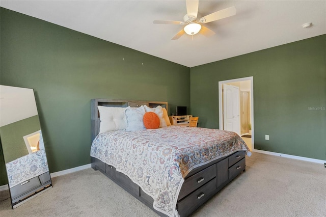 carpeted bedroom with ensuite bathroom and ceiling fan