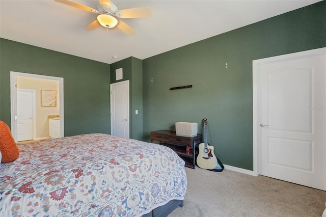 bedroom with carpet, ceiling fan, and connected bathroom