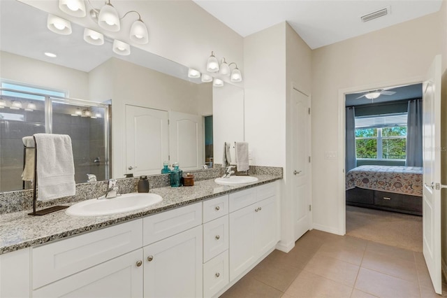 bathroom with tile patterned floors, ceiling fan, vanity, and walk in shower