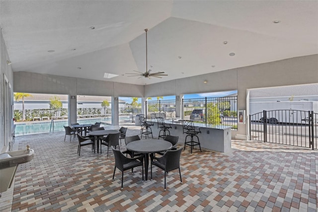 sunroom / solarium with plenty of natural light, ceiling fan, and vaulted ceiling