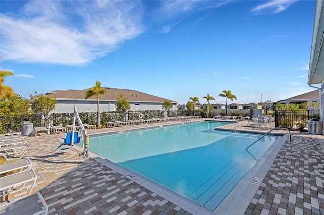 view of swimming pool featuring central air condition unit and a patio area