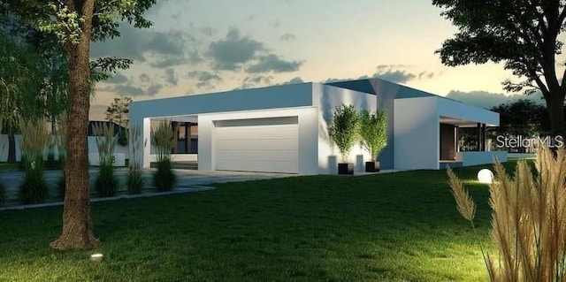 exterior space with a garage and a yard