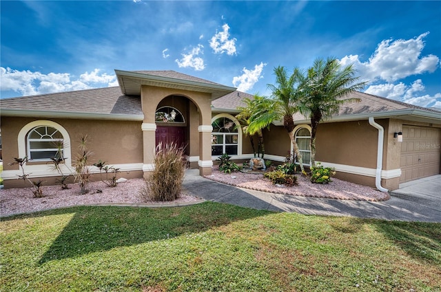 view of front of house with a garage and a front yard