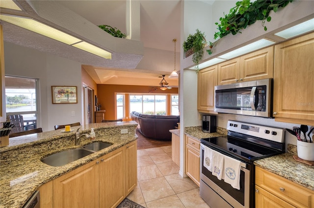 kitchen featuring stainless steel appliances, a wealth of natural light, sink, and pendant lighting