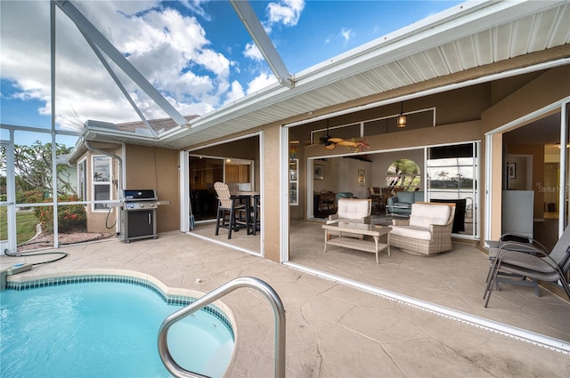 view of swimming pool featuring area for grilling, glass enclosure, a patio, and ceiling fan