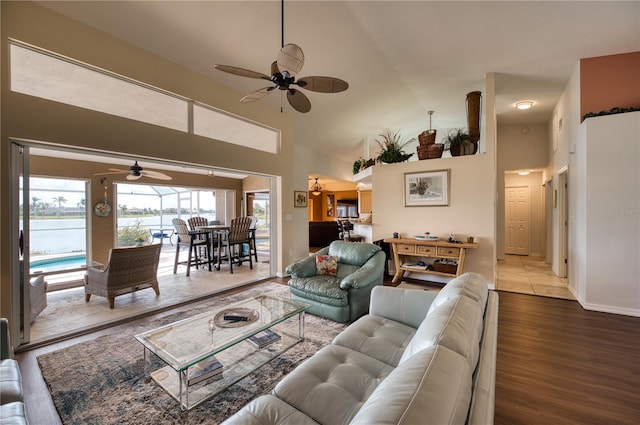 living room with high vaulted ceiling, hardwood / wood-style flooring, and ceiling fan