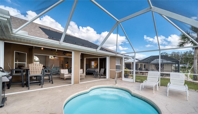 view of swimming pool featuring a lanai and a patio area