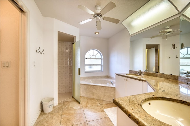 bathroom featuring vanity, a textured ceiling, plus walk in shower, tile patterned flooring, and ceiling fan