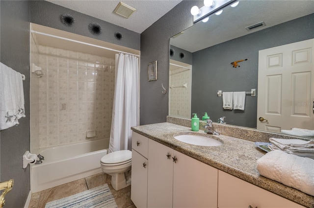 full bathroom with vanity, a textured ceiling, tile patterned flooring, toilet, and shower / bath combo with shower curtain