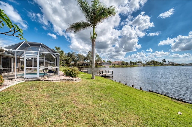 view of yard featuring a water view, glass enclosure, a dock, and a patio area