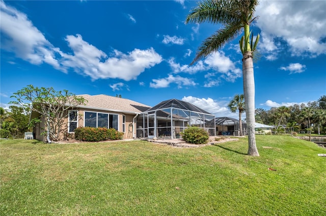 rear view of property featuring a yard and a lanai