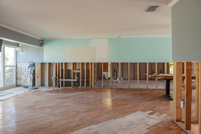 miscellaneous room with hardwood / wood-style floors and crown molding