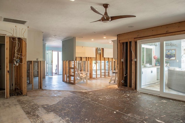 empty room with ceiling fan and plenty of natural light