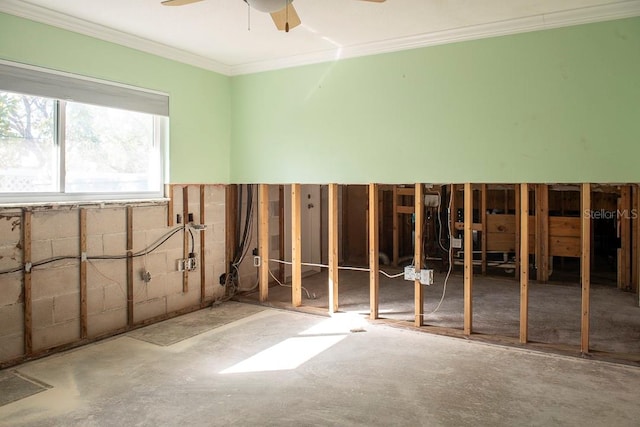 interior space with ornamental molding and ceiling fan