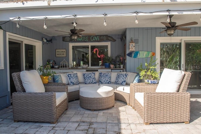 view of patio featuring an outdoor living space, sink, and ceiling fan