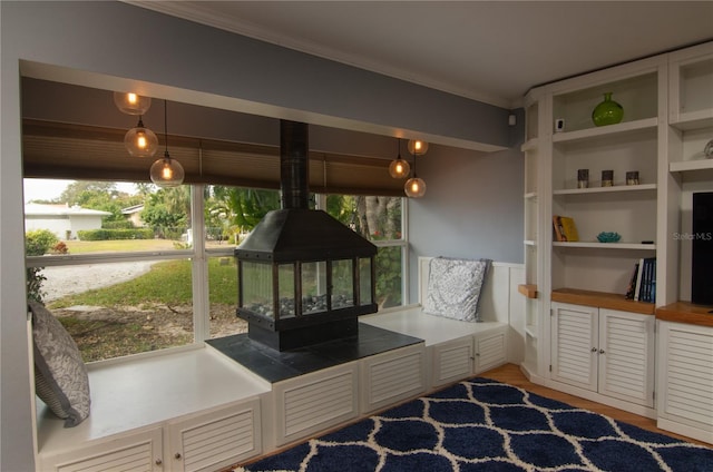 living area featuring wood-type flooring and crown molding