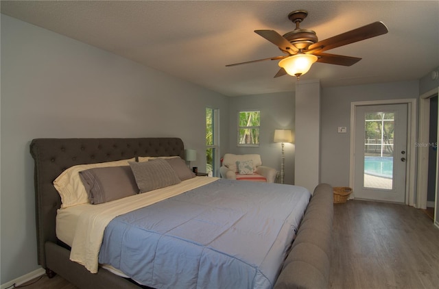 bedroom featuring a textured ceiling, hardwood / wood-style flooring, ceiling fan, and access to exterior