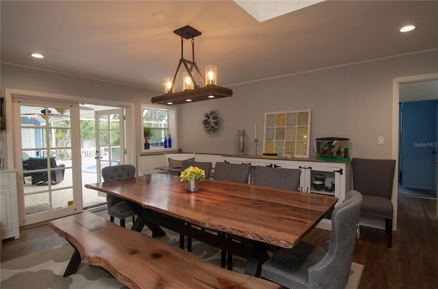 dining area featuring dark wood-type flooring and a chandelier