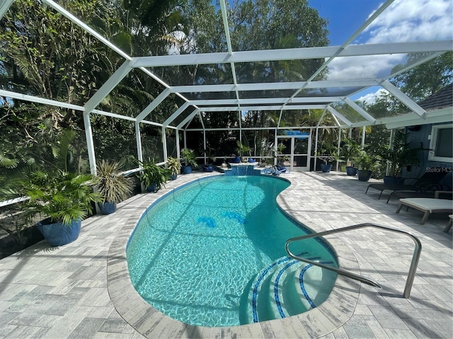 view of pool featuring a lanai and a patio