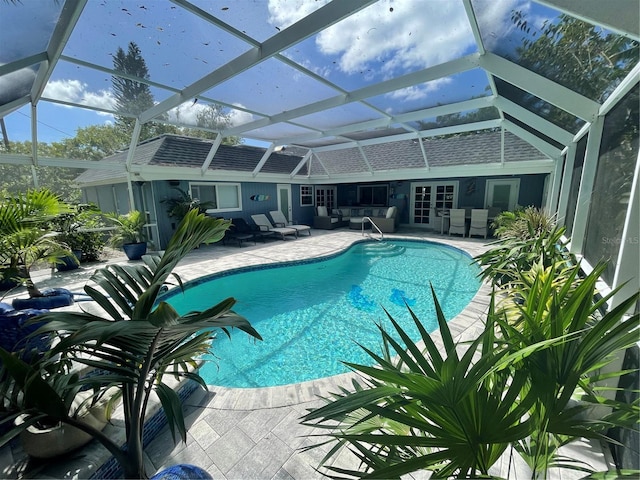 view of swimming pool featuring a lanai and a patio area