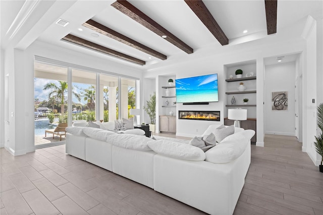 living room with built in features, beam ceiling, crown molding, and light hardwood / wood-style flooring