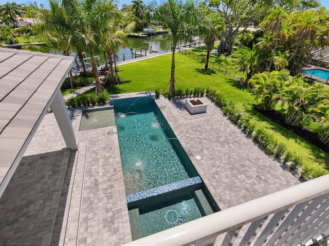 view of pool featuring a water view, a lawn, a patio, and pool water feature