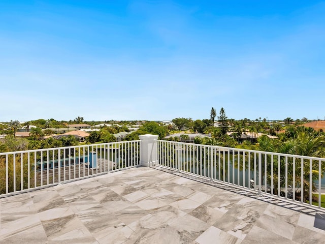 view of patio with a balcony and a water view