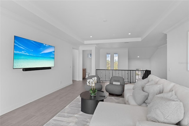 living room featuring light hardwood / wood-style floors and crown molding