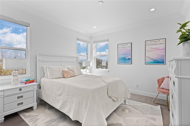 bedroom with ornamental molding and hardwood / wood-style flooring